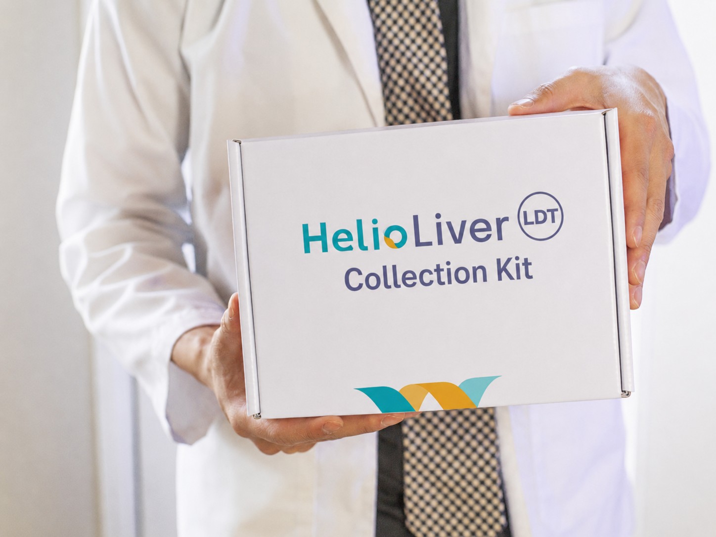 A clinician holding the HelioLiver blood collection kit